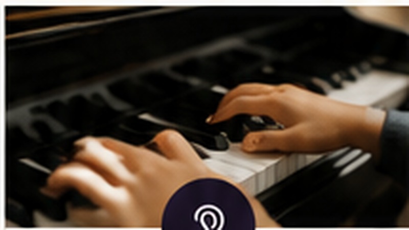 Hands playing a piano keyboard